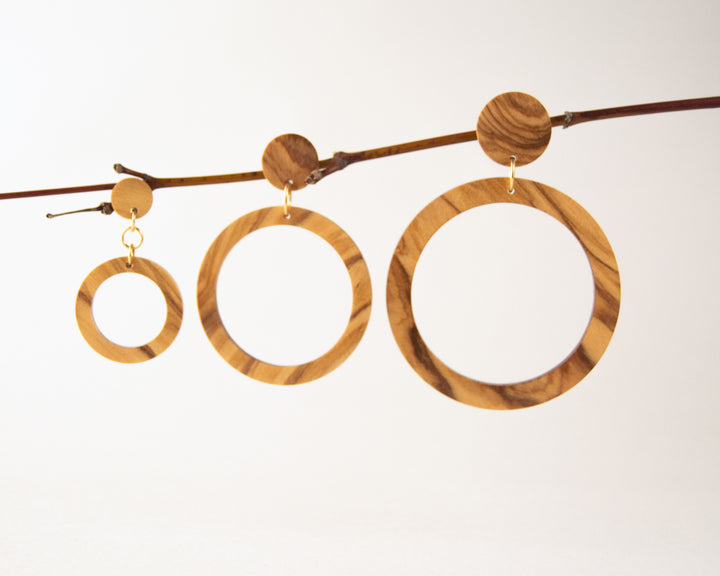3 sizes of olive wood hoops hanging from twig