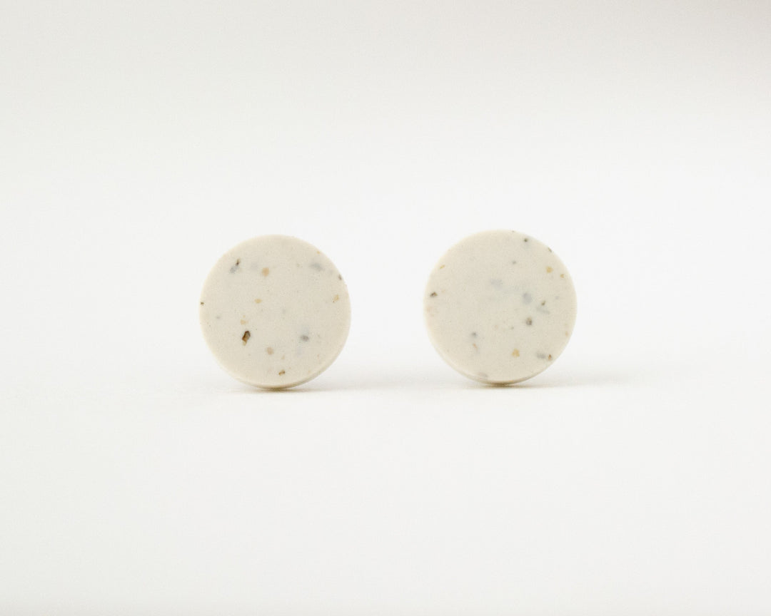 off-white stud earrings with speckles front