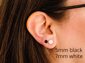 model wearing 7mm and 5mm stud earrings on same ear