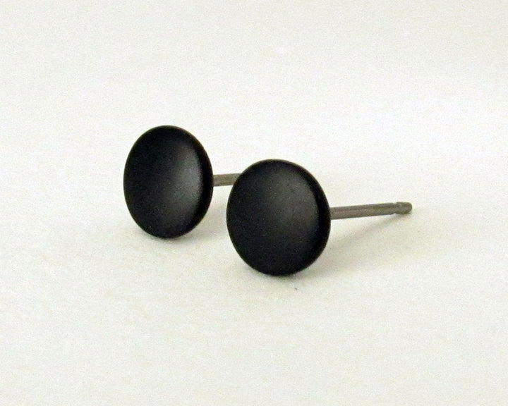 black stud earrings at a 45 degree angle